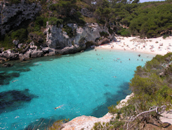 Cala Macarelleta beach boasts golden sand and turquoise blue waters